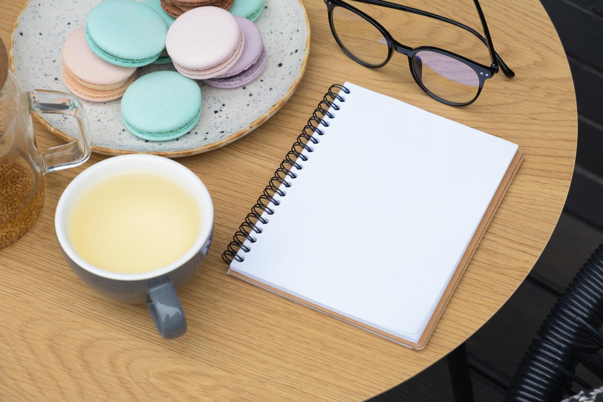 stack of recipe booklets and a cup of coffee